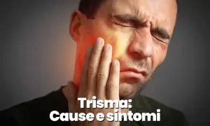 Uomo con mano sulla guancia, evidenziando il dolore alla mascella e le sue cause.